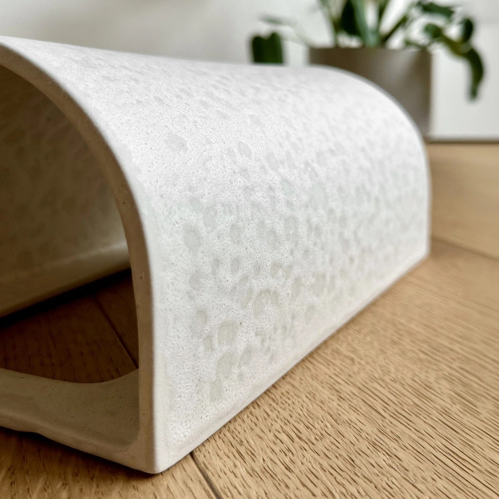 close-up detail of the raw white ceramic wall light showing its texture and practical e27 bulb socket