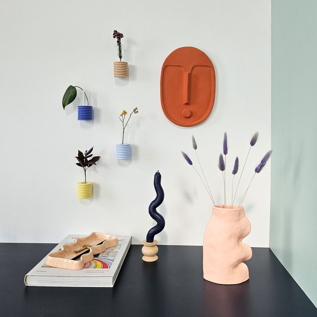elegant terracotta ceramic wall mask with a refined matte glaze and textured finish