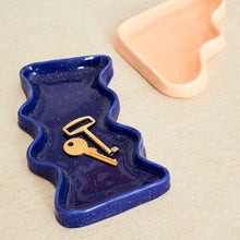 playful blue speckled ceramic wave tray on a sunny windowsill, catching light for keys or trinkets