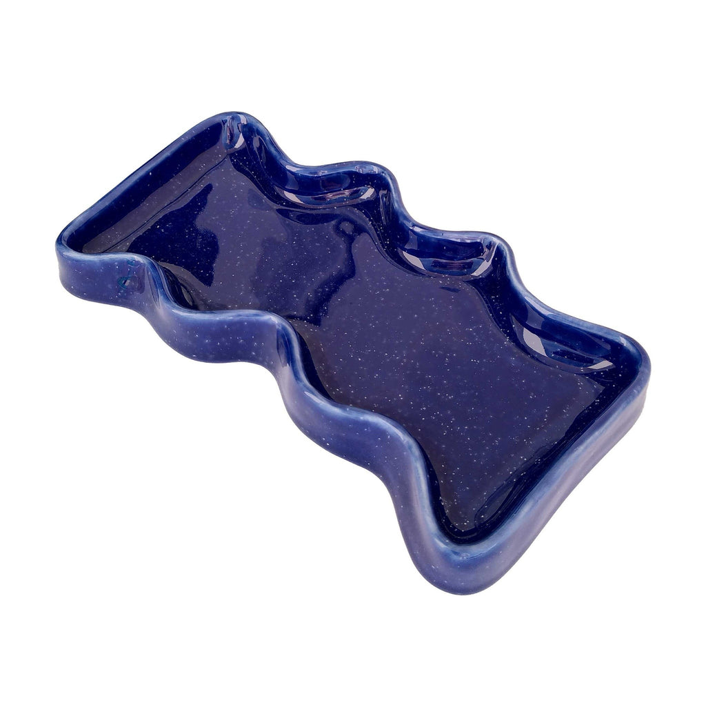 speckled blue ceramic wave tray on a wooden table, holding keys and coins, practical and stylish