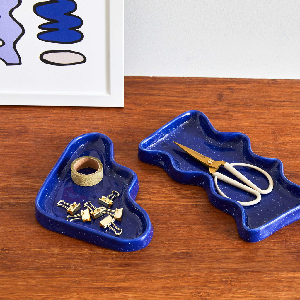 blue speckled ceramic wave tray on a wooden table, functional and practical for keys or jewelry