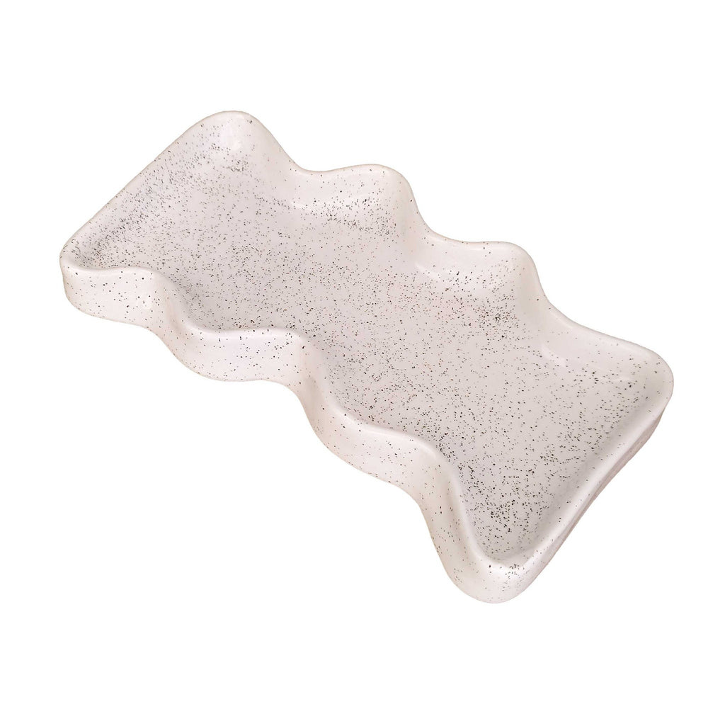 white speckled ceramic wave tray on a wooden table, holding keys and coins, functional and minimalist