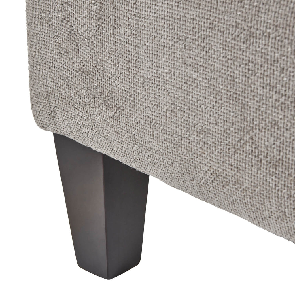 Taupe velvet ottoman footstool with wooden legs, plush cushioning, and modern farmhouse design by sostter at brixbailey.com