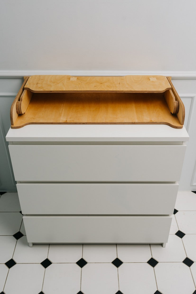 birch plywood changing table top on a chest of drawers, showcasing its practical depth and back extension for stability