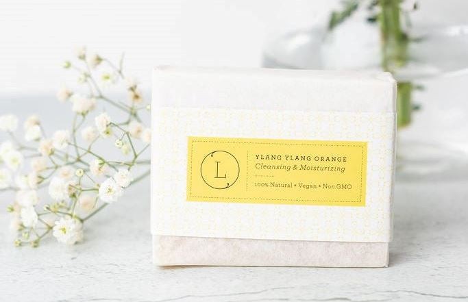 a close-up of the grapefruit shea butter and body oil from the citrus cheer up gift basket