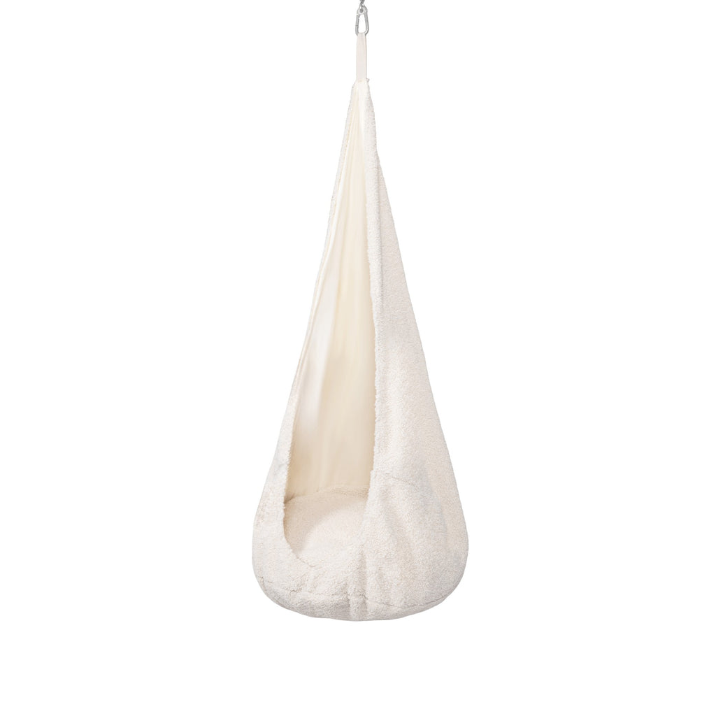 a soft, textured fabric cocoon swing for kids, gently lit and looking like a cozy, inviting hideout