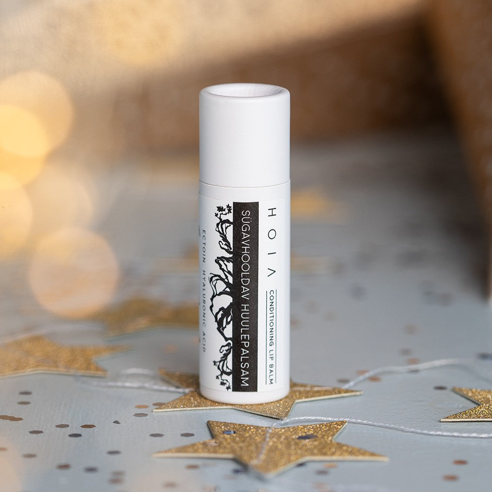 a bold close-up of the nourishing lip balm with ectoin and hyaluronic acid against a stark background