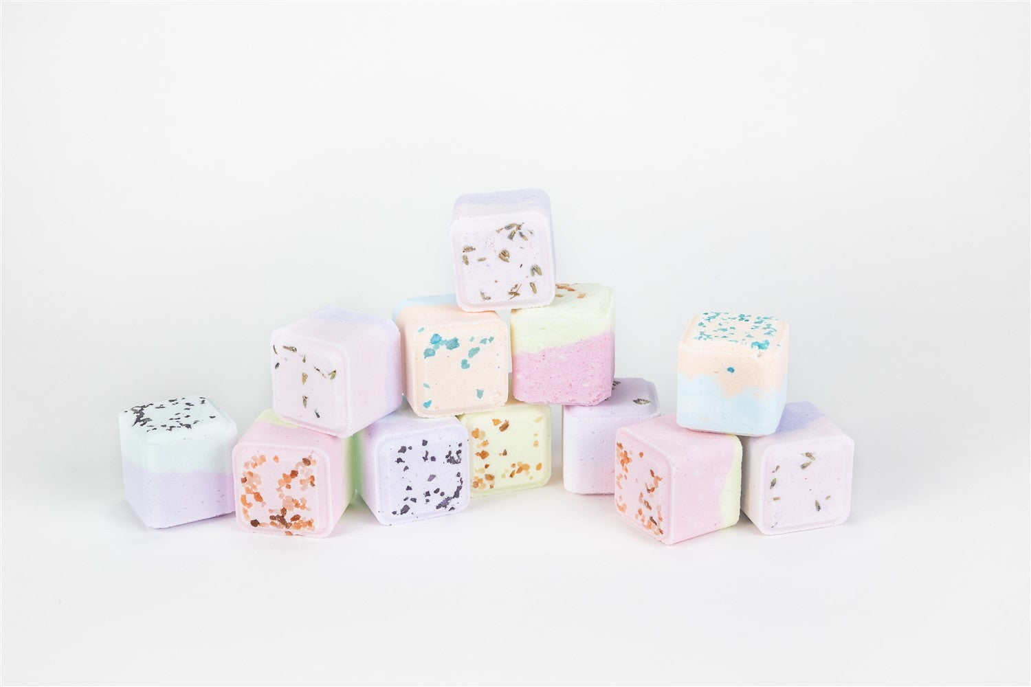 playful celebration gift box with grapefruit bath bomb and white candy on a vibrant towel