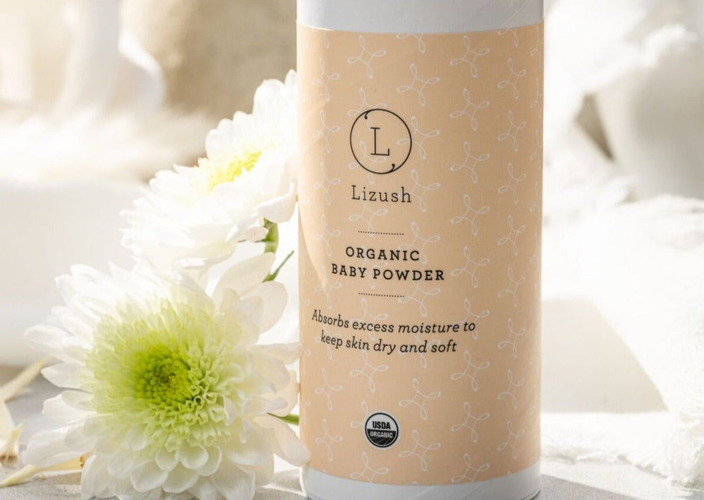 close-up of a dribble bib and organic balms from a handmade baby gift set on a rustic wooden table