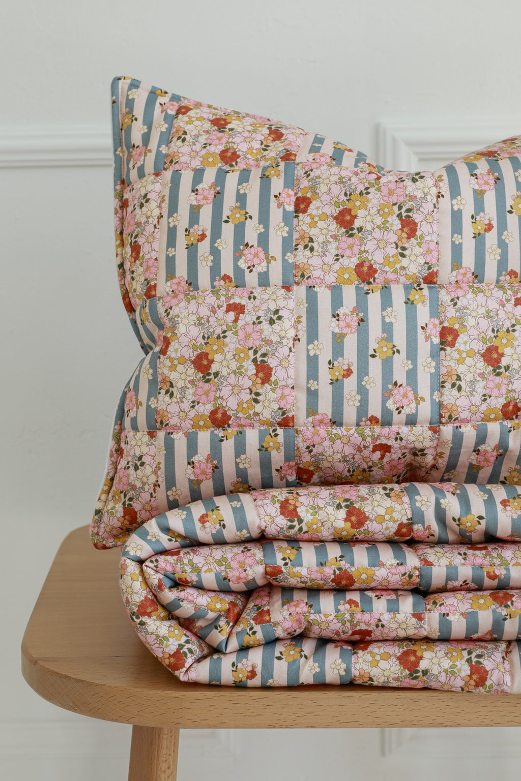 bold summer garden cotton quilted blanket and pillow set - vibrant patchwork on wooden floor