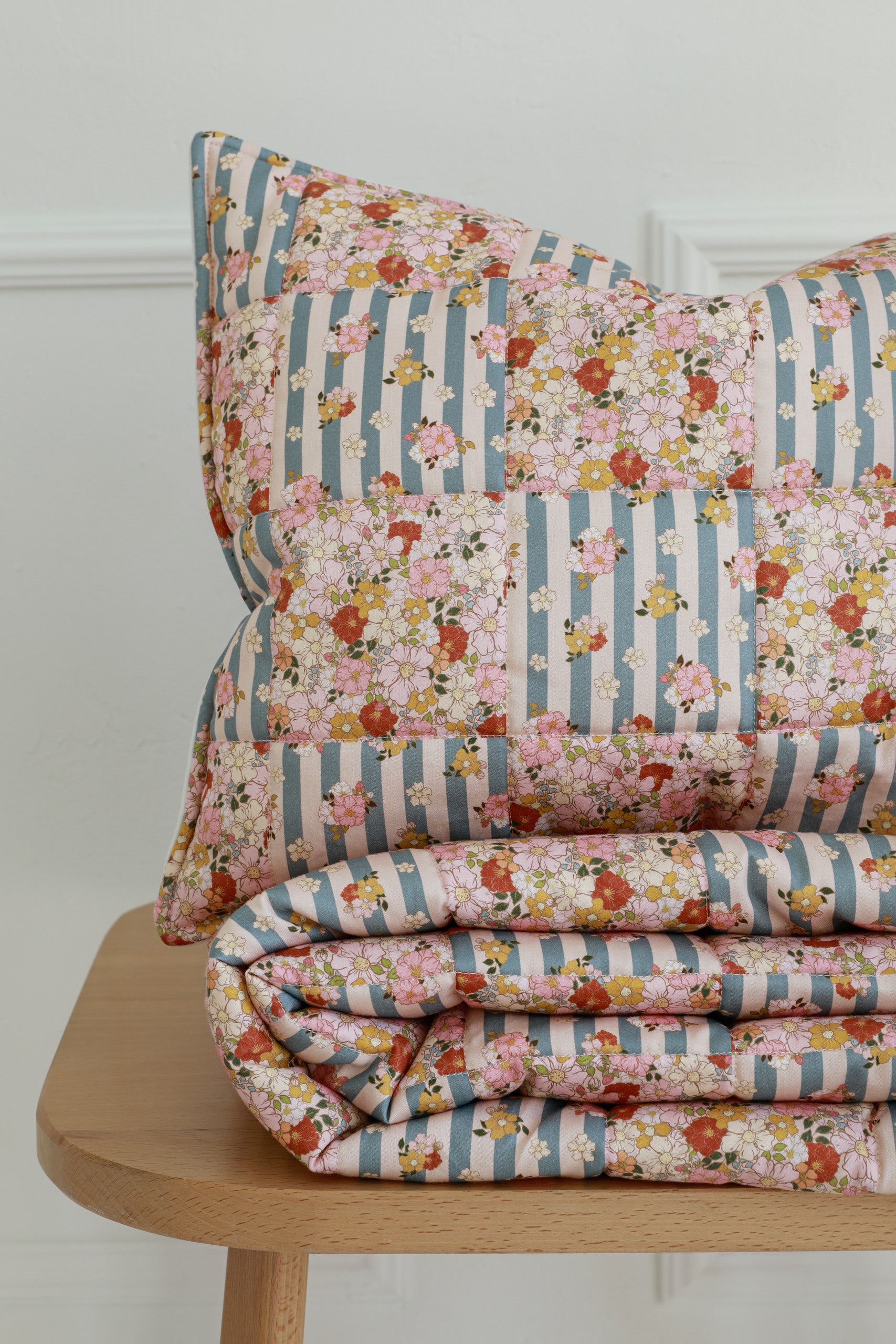 bold summer garden cotton quilted blanket and pillow set - vibrant patchwork on wooden floor