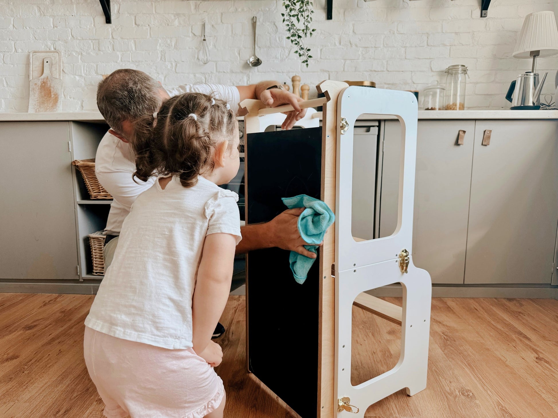 a soft-lit view of the sustainable kids tower with blackboard, set in a cozy nursery