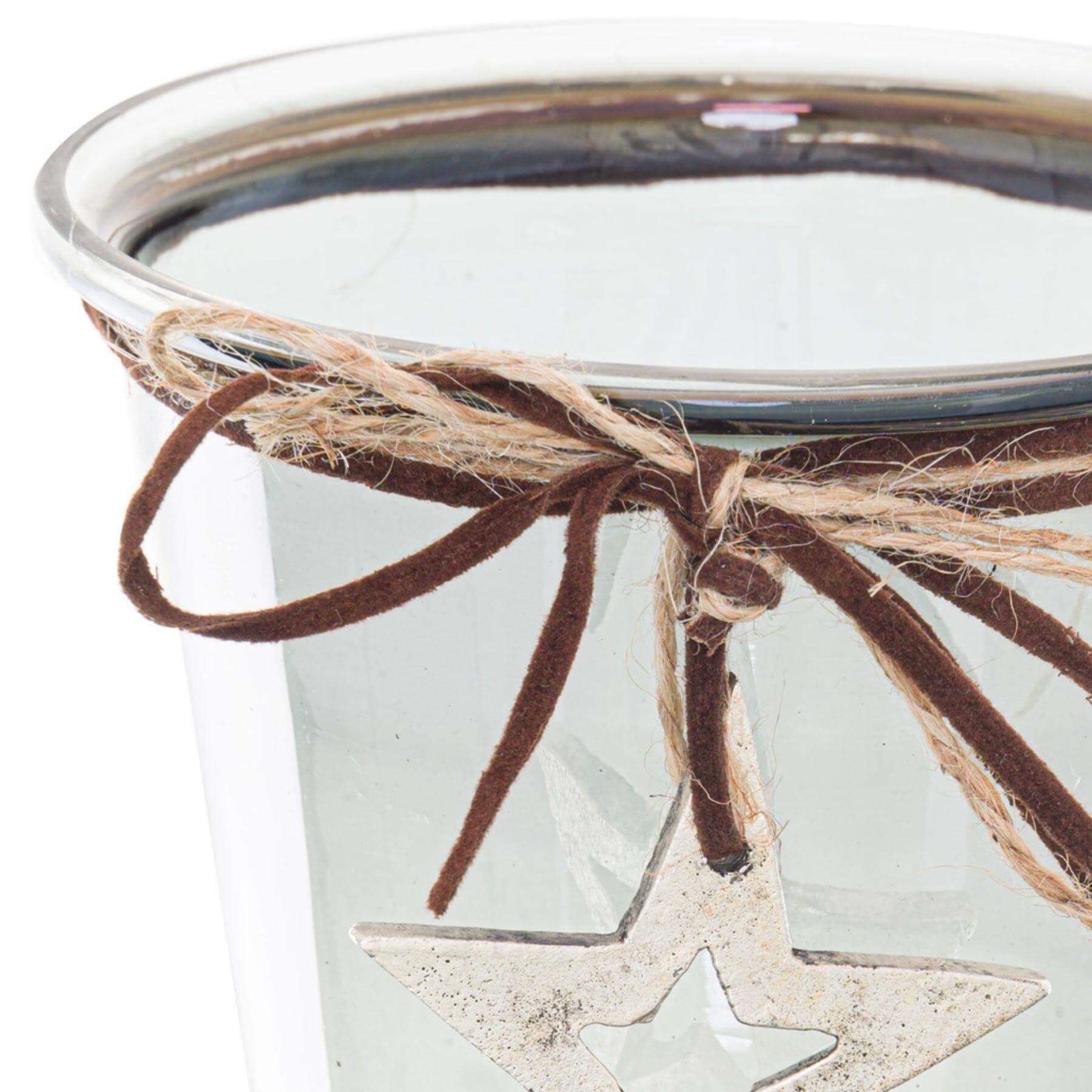 Smoked Midnight hammered star glass candle holder with twine bow, creating warm holiday ambiance. by Sostter at brixbailey.com