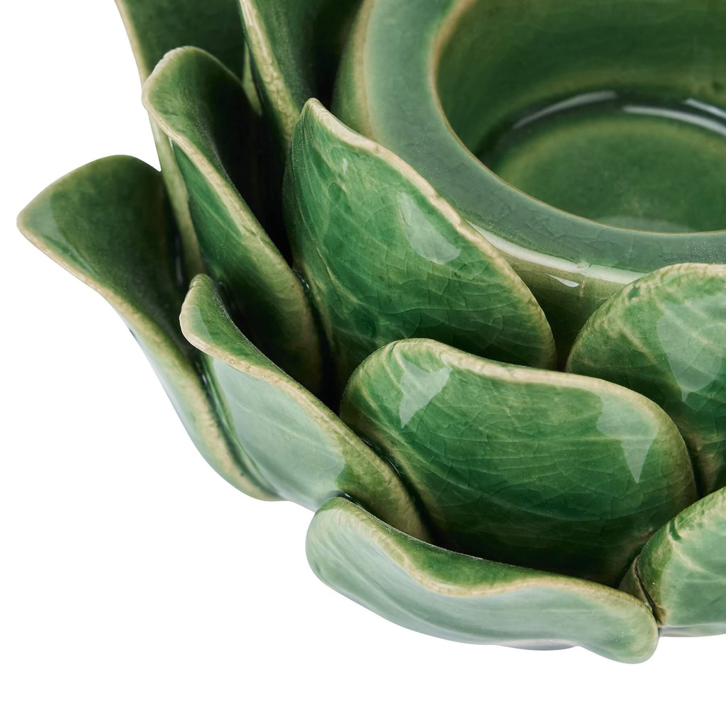 Handcrafted ceramic tea light holder in botanical green with artichoke cutouts, casting intricate shadow patterns. by RoomLondon at brixbailey.com