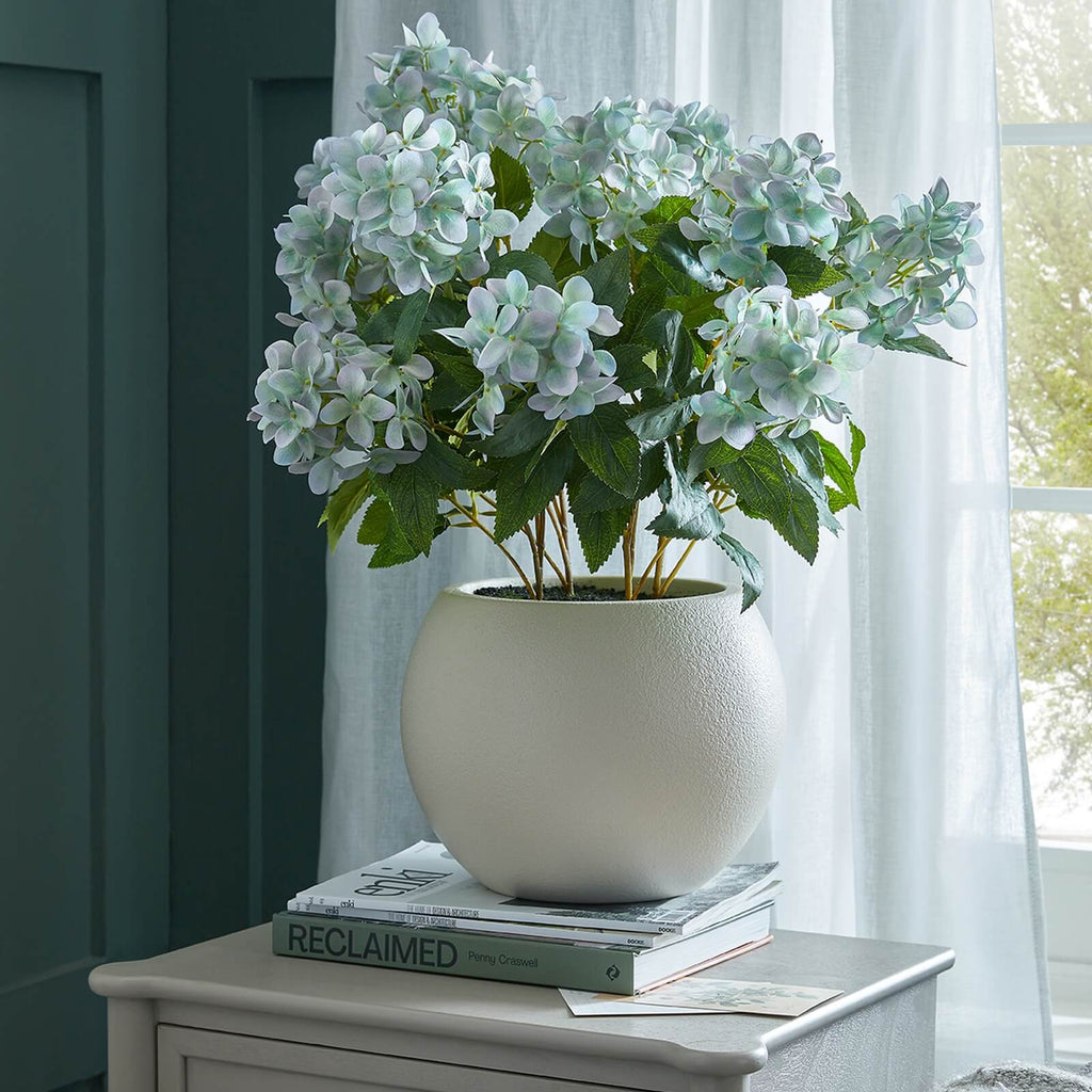 Lifelike faux Hellebore plant with vibrant green blooms in taupe ceramic pot, perfect for farmhouse or modern decor by Sostter at brixbailey.com