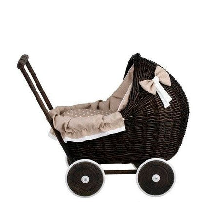 softly lit dark wicker doll pram with cozy beige bedding from a comforting side angle