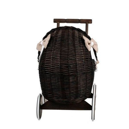 close-up of the dark wicker doll pram's durable construction and beige bedding set