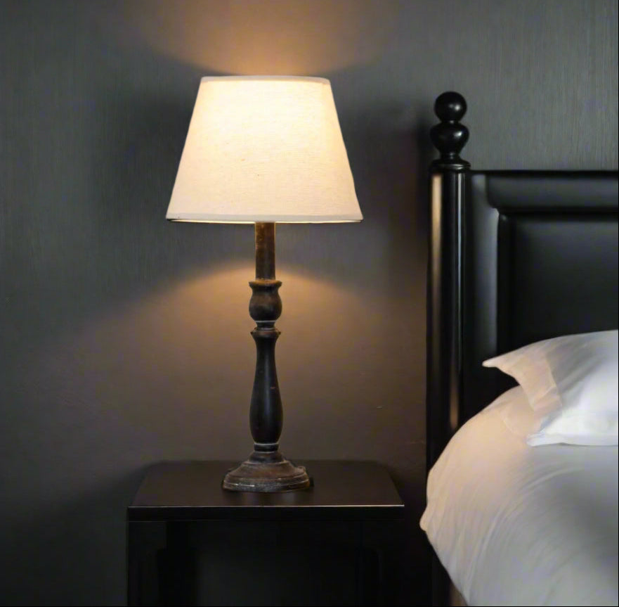 Ravenna Column Table Lamp with distressed black wood base and neutral linen shade for rustic-modern decor by Sostter at brixbailey.com