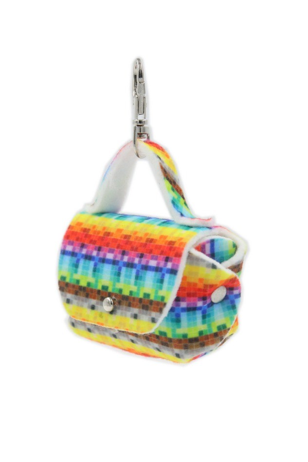 playful pixel-patterned dog bag dispenser clipped to a leash on a sunny walk