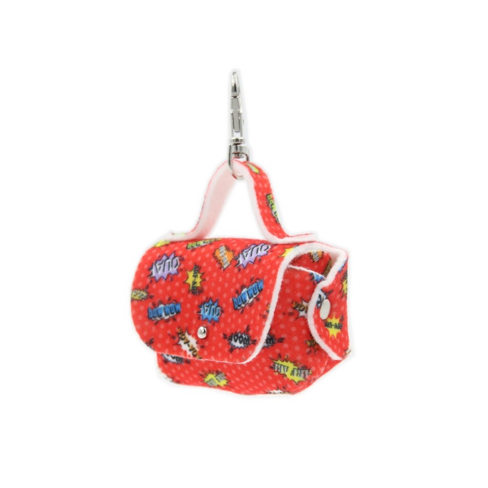 soft red graffiti dog bag dispenser on a leash in warm morning light