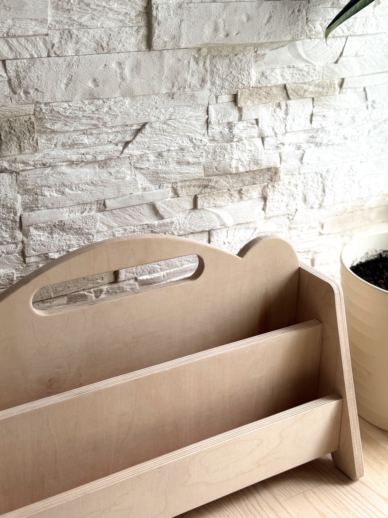 a playful double-sided kids bookshelf in a sunny reading nook, filled with colorful picture books