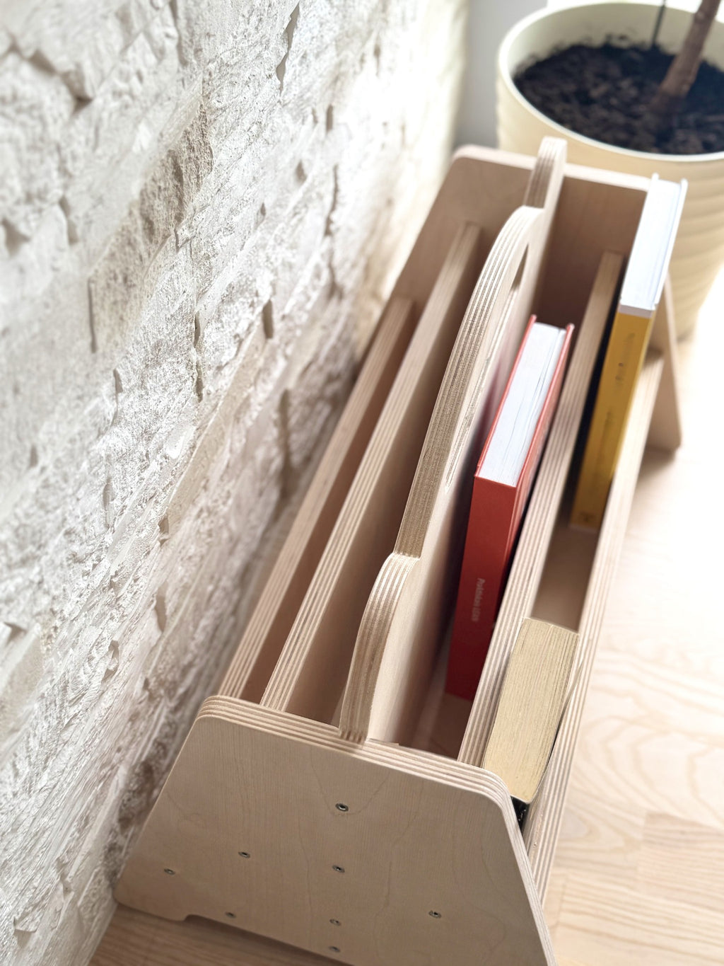 elegant birch bookshelf in a softly lit nursery with a curated selection of childrens books