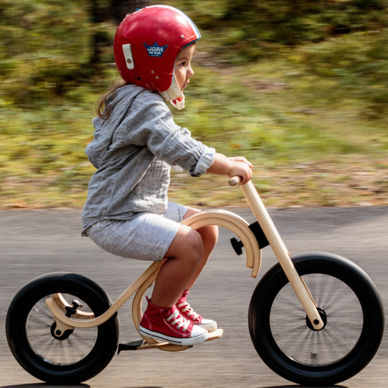bold close-up of the downhill footrest and brake add-on for a child's balance bike