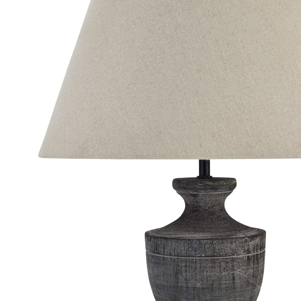 a playful wooden lamp with a linen shade casting a fun, patterned shadow