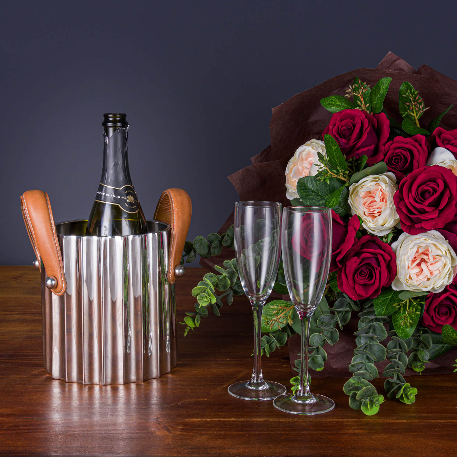 Silver fluted champagne cooler with leather handles, stainless steel, elegant ridges for light reflection, versatile centerpiece by RoomLondon at brixbailey.com