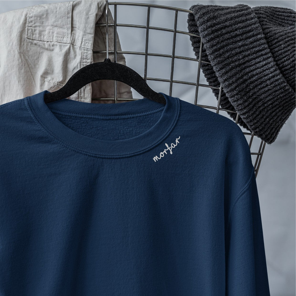 close-up of the embroidered morfar collar on a soft organic cotton sweatshirt, showing fabric texture