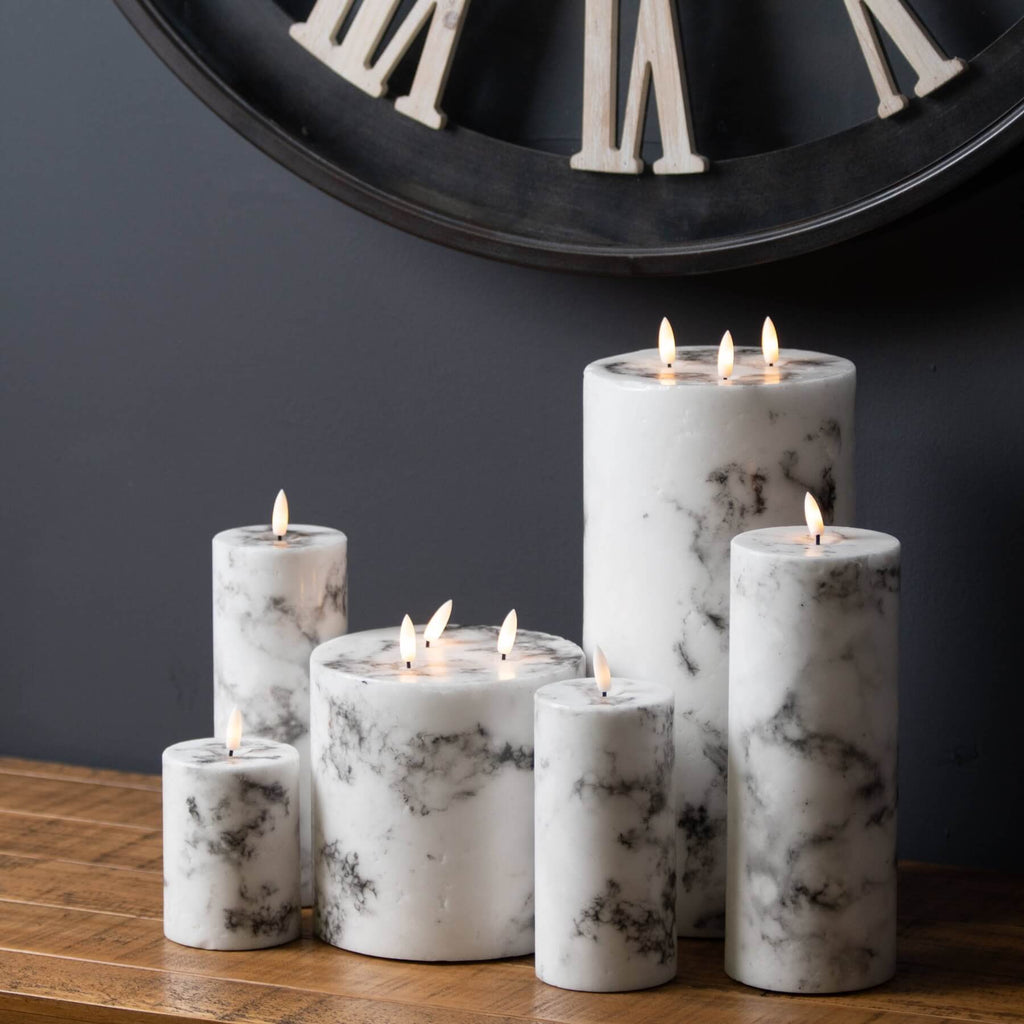 White marble-effect LED pillar candle with realistic flickering flame and veining patterns, battery-operated for safe ambiance. by RoomLondon at brixbailey.com