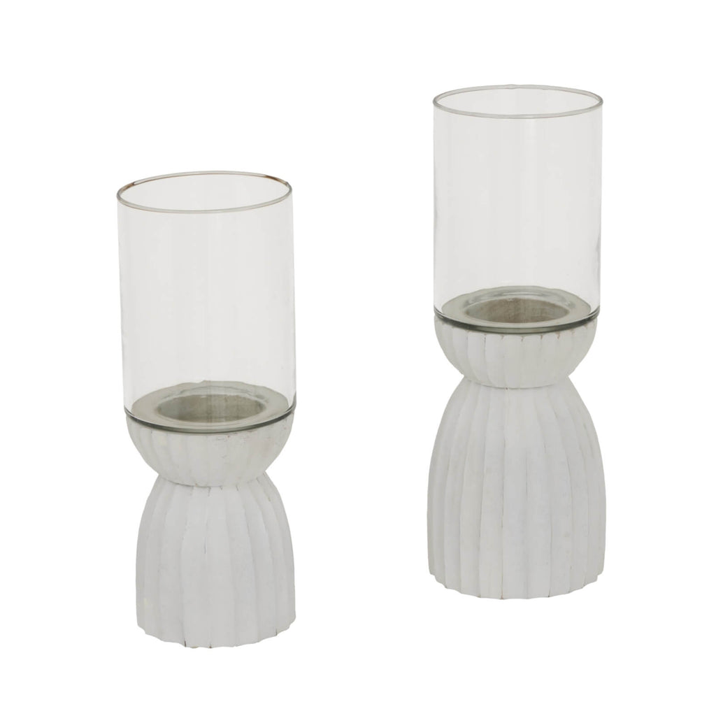 White carved hurricane lantern with intricate geometric patterns, durable glass, warm atmospheric glow by RoomLondon at brixbailey.com