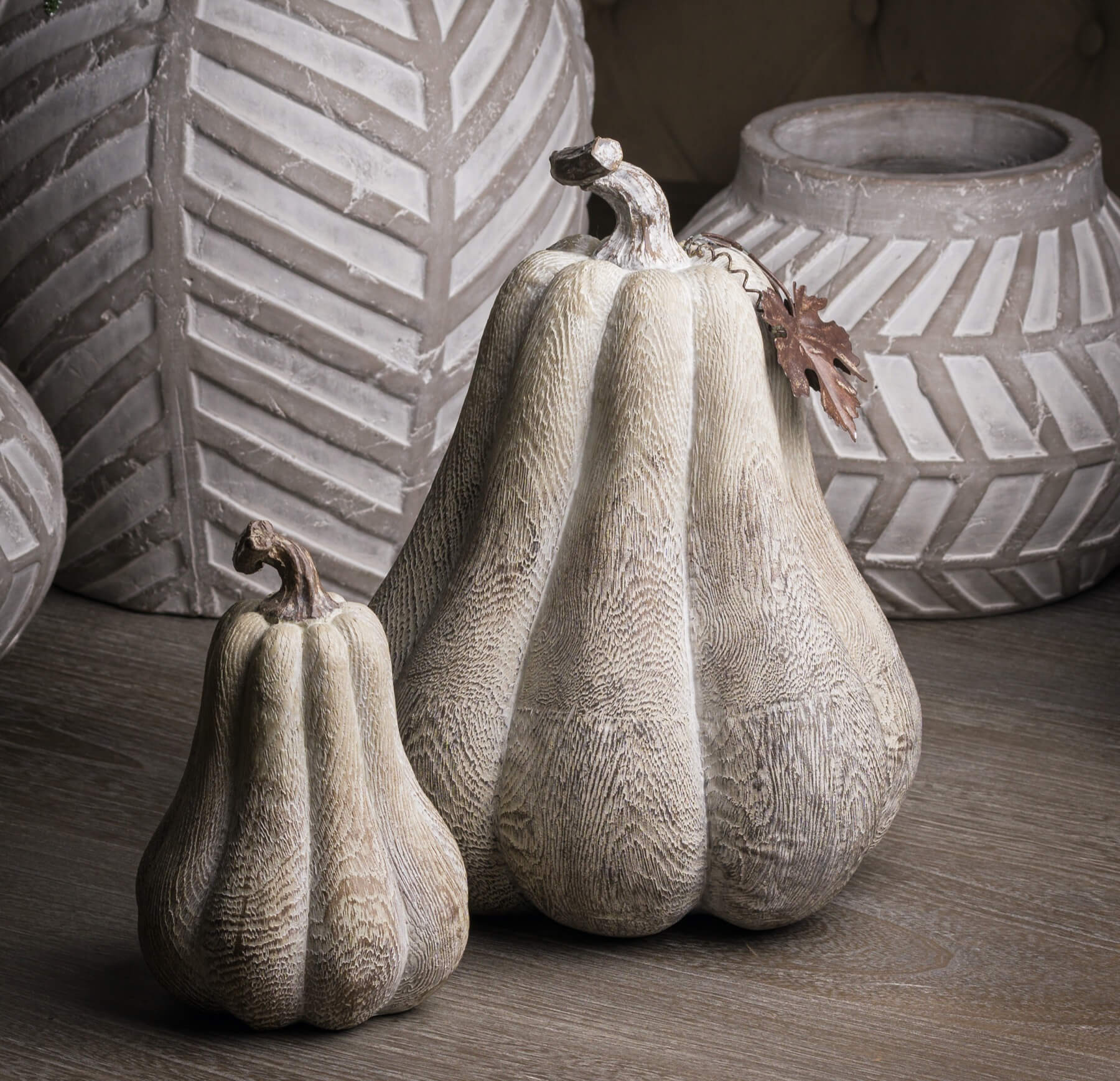 Handcrafted wood-effect resin pumpkin with whitewashed finish, bronze leaf accents, and wooden stalk for autumn decor by RoomLondon at brixbailey.com