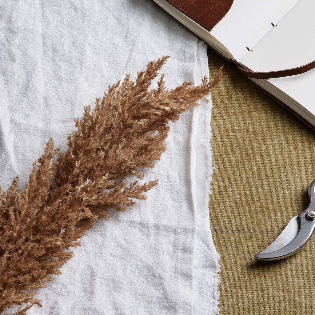 Lifelike faux pampas grass stem in soft taupe, 68cm tall, for elegant home decor with natural movement by sostter at brixbailey.com
