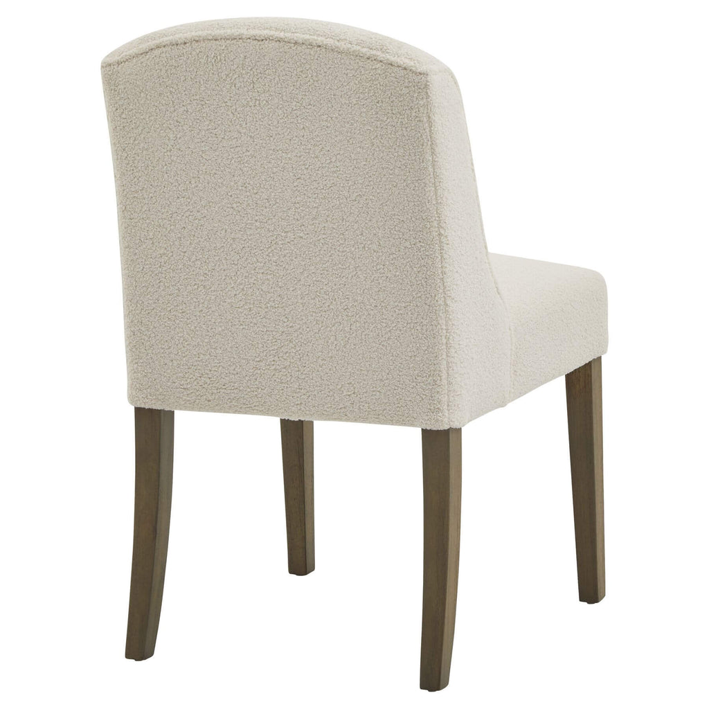 Cream bouclÃ© dining chair with rubberwood frame, modern silhouette, and quiet luxury aesthetic by Sostter at brixbailey.com