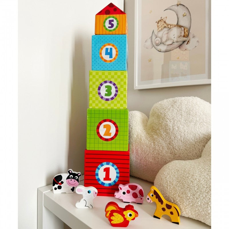 soft morning light on a child's hands gently placing a wooden cow into its illustrated cube