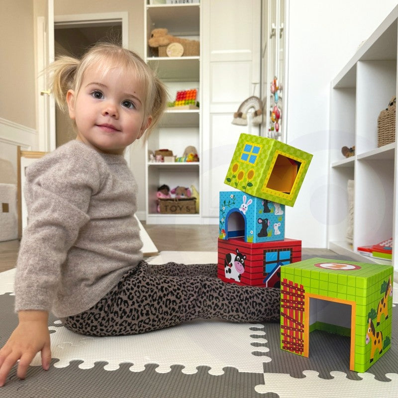 playful toddler stacking colorful farm cubes with a wooden cow peeking out