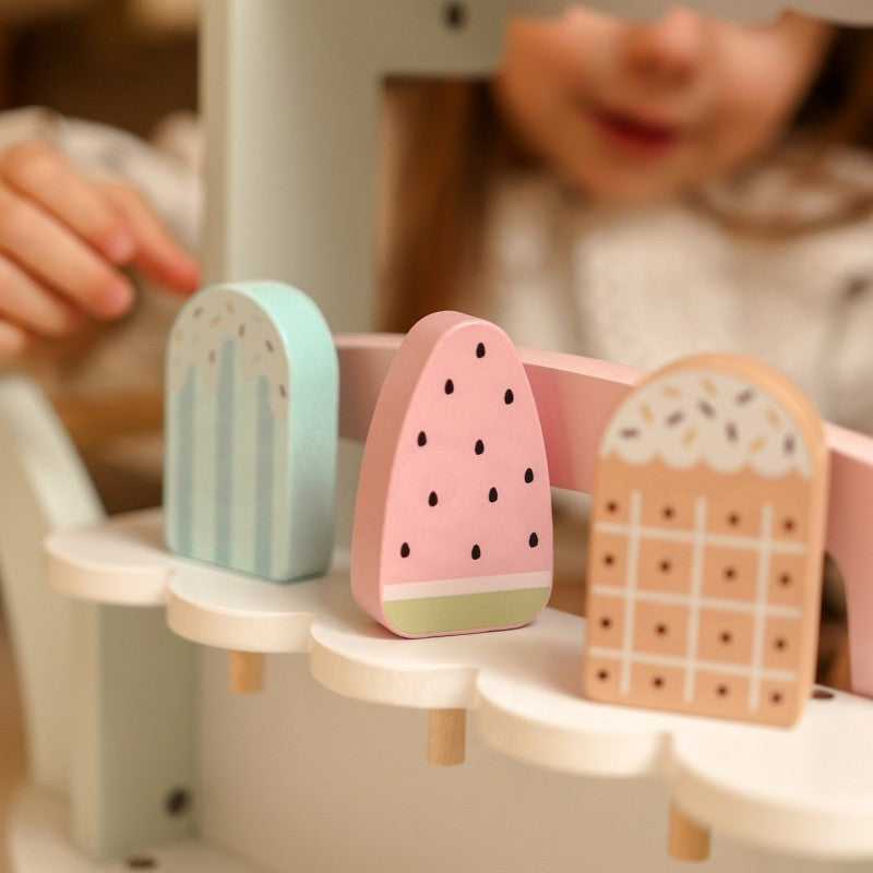 soft-lit close-up of the woopie green ice cream cart's pastel details and magnetic scoops