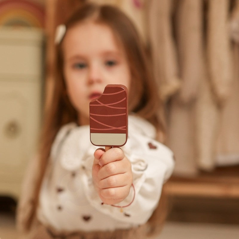 child playing with a vibrant pastel green ice cream cart and magnetic scoops