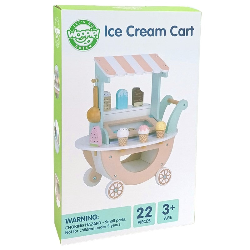 child's hands arranging magnetic ice cream scoops on the pastel green cart