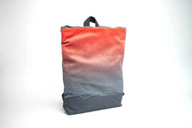 elegant salmon faux leather backpack with velvet muni design, open to show spacious laptop compartment