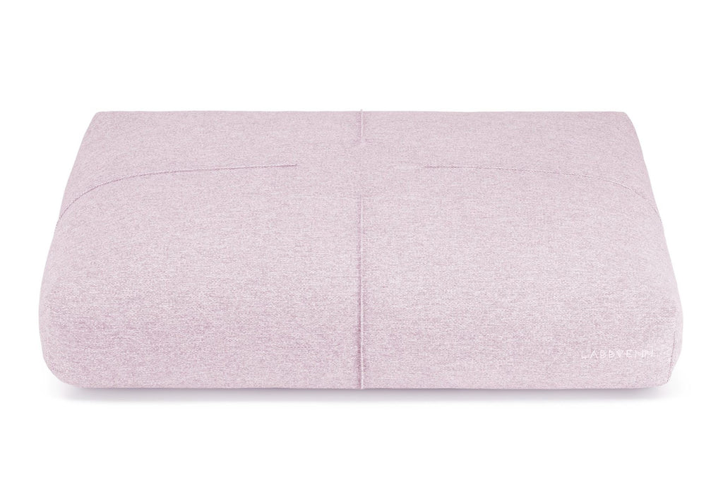 soft pink finno dog cushion with elegant stitching on a cozy bed