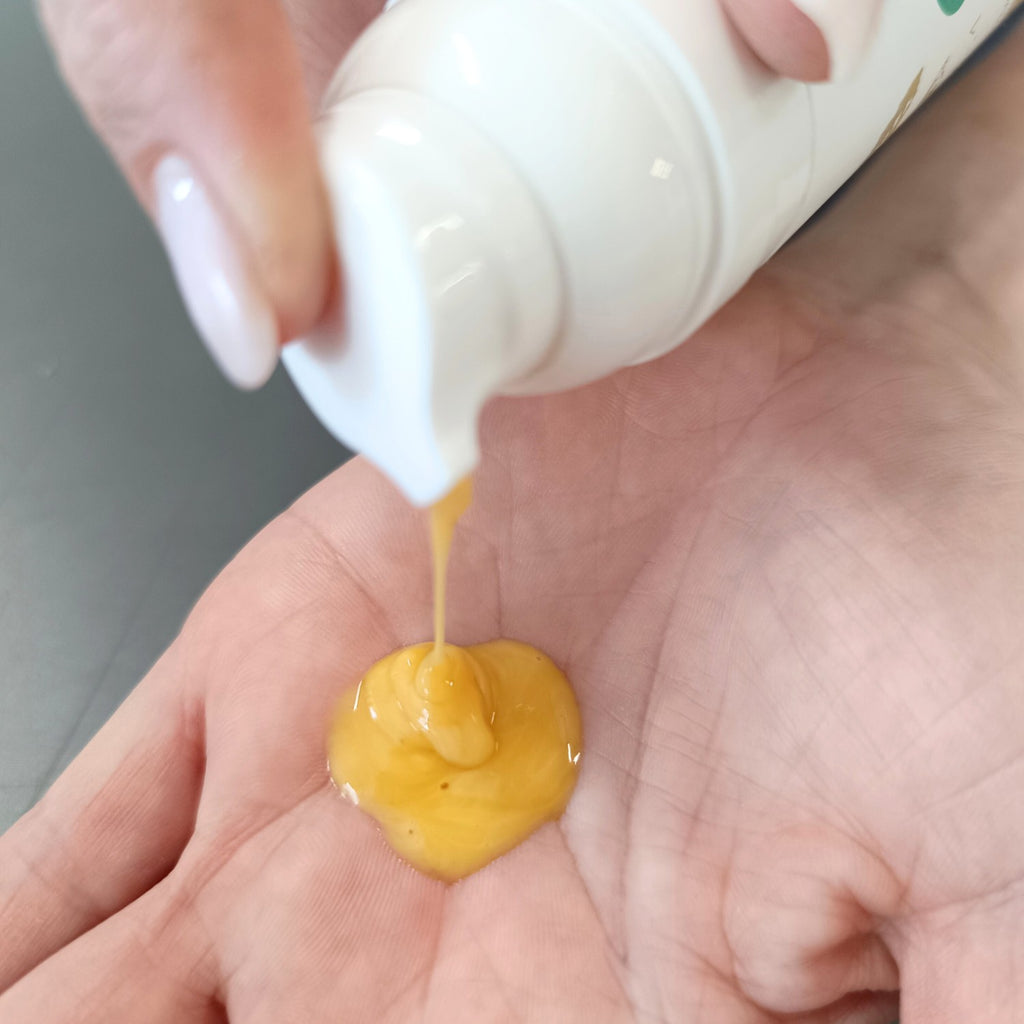 a gentle hand holding firming cellulite cream with soft morning light