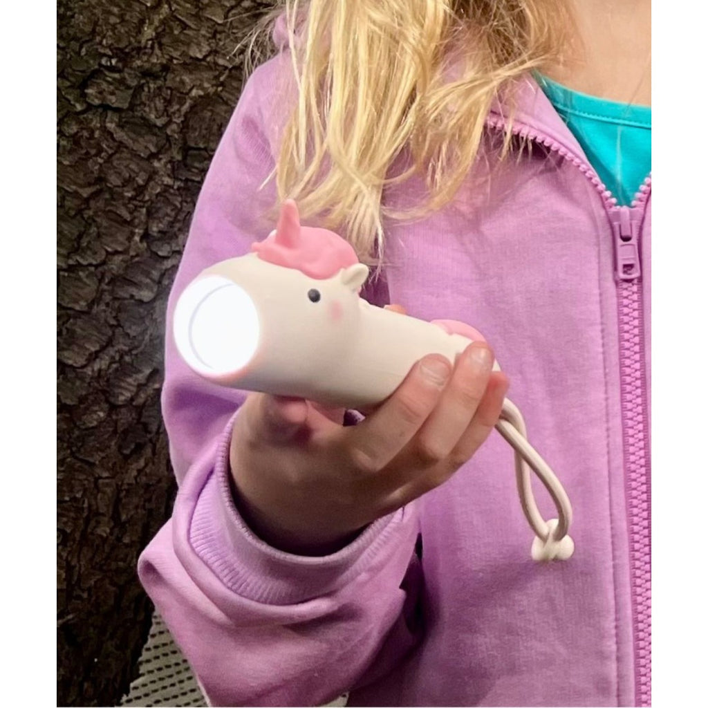 soft pink unicorn flashlight casting a gentle glow for bedtime stories