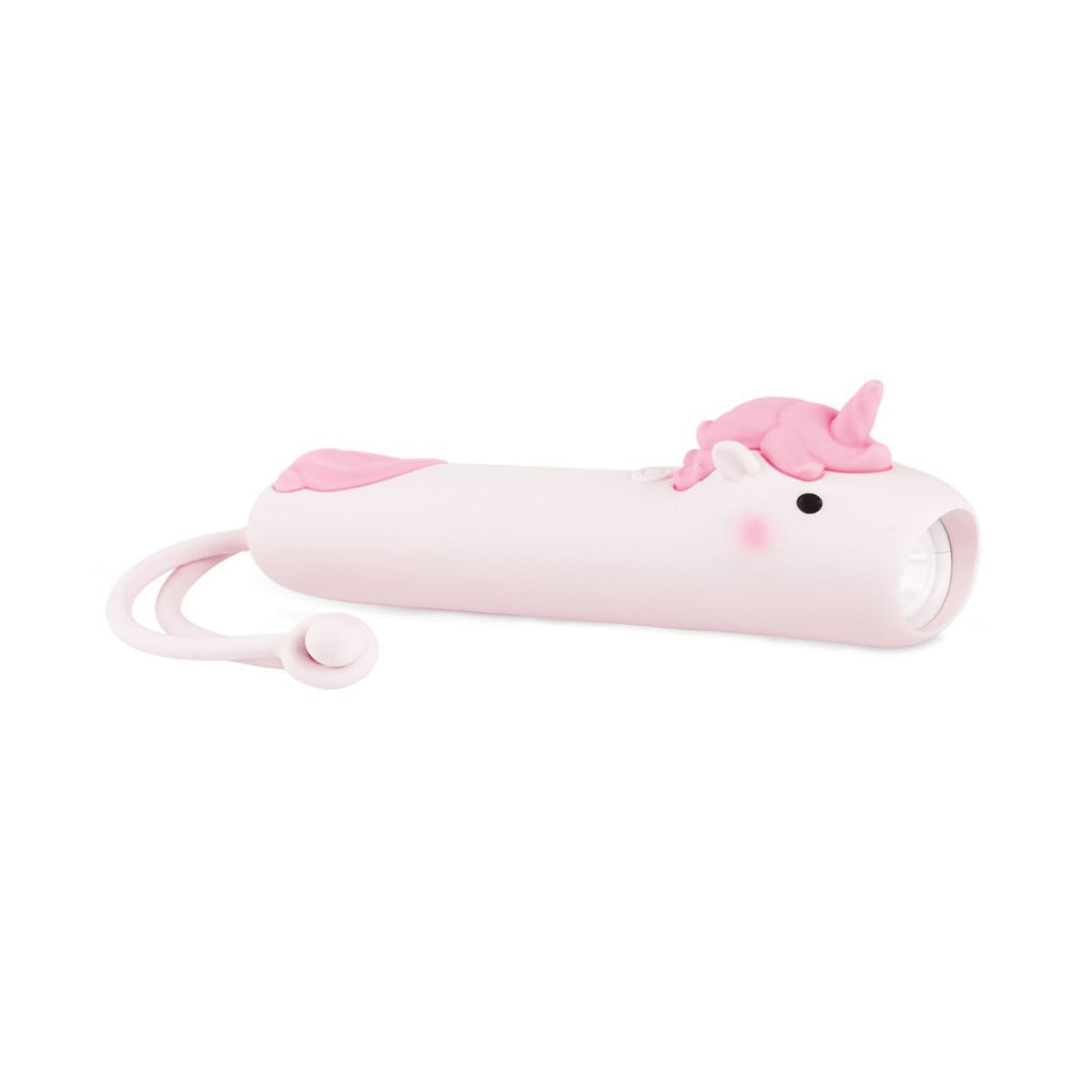 soft silicone unicorn flashlight for kids casting a warm pink glow in a cozy bedroom