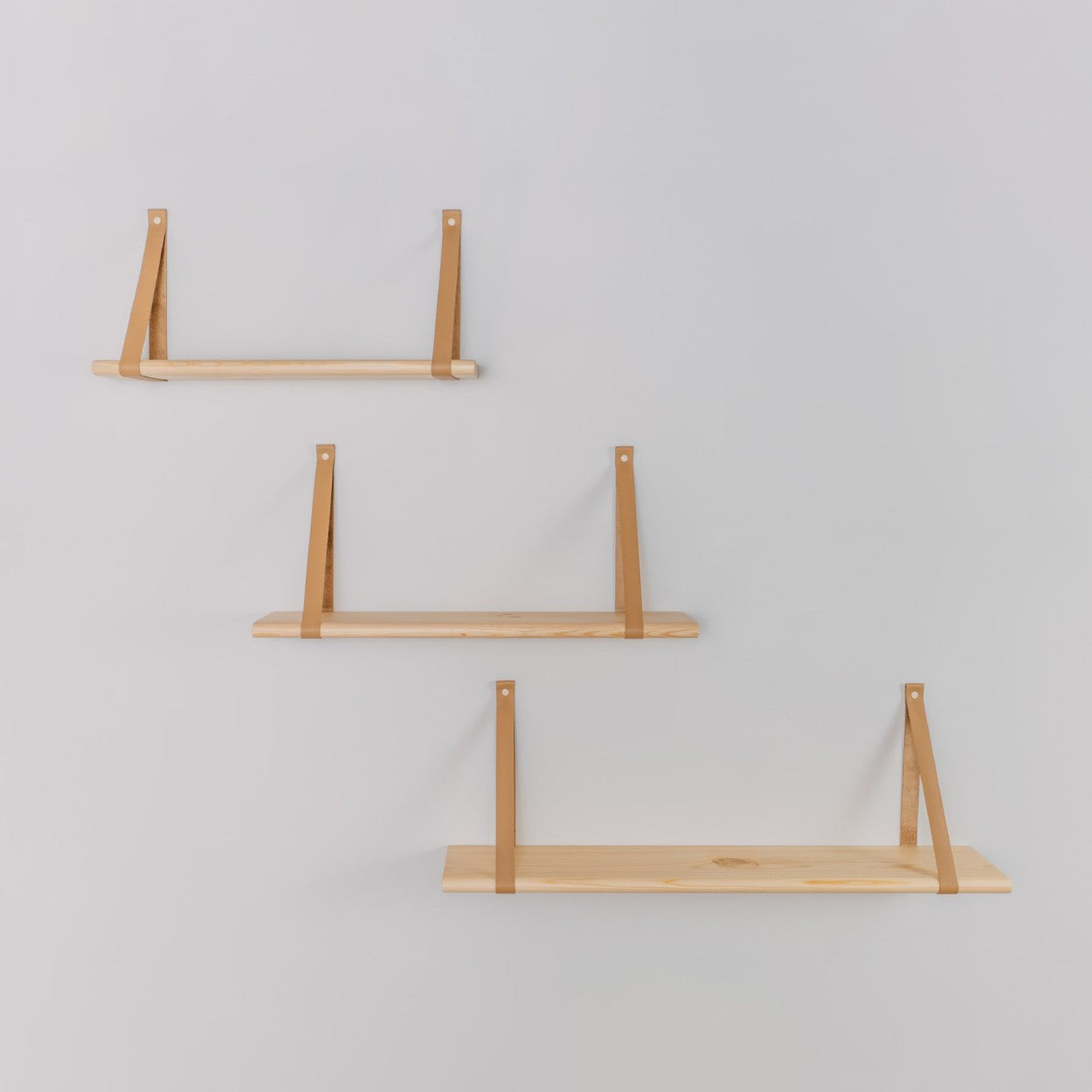 elegant 60 cm solid pine floating shelf with soft camel leather straps in a refined setting
