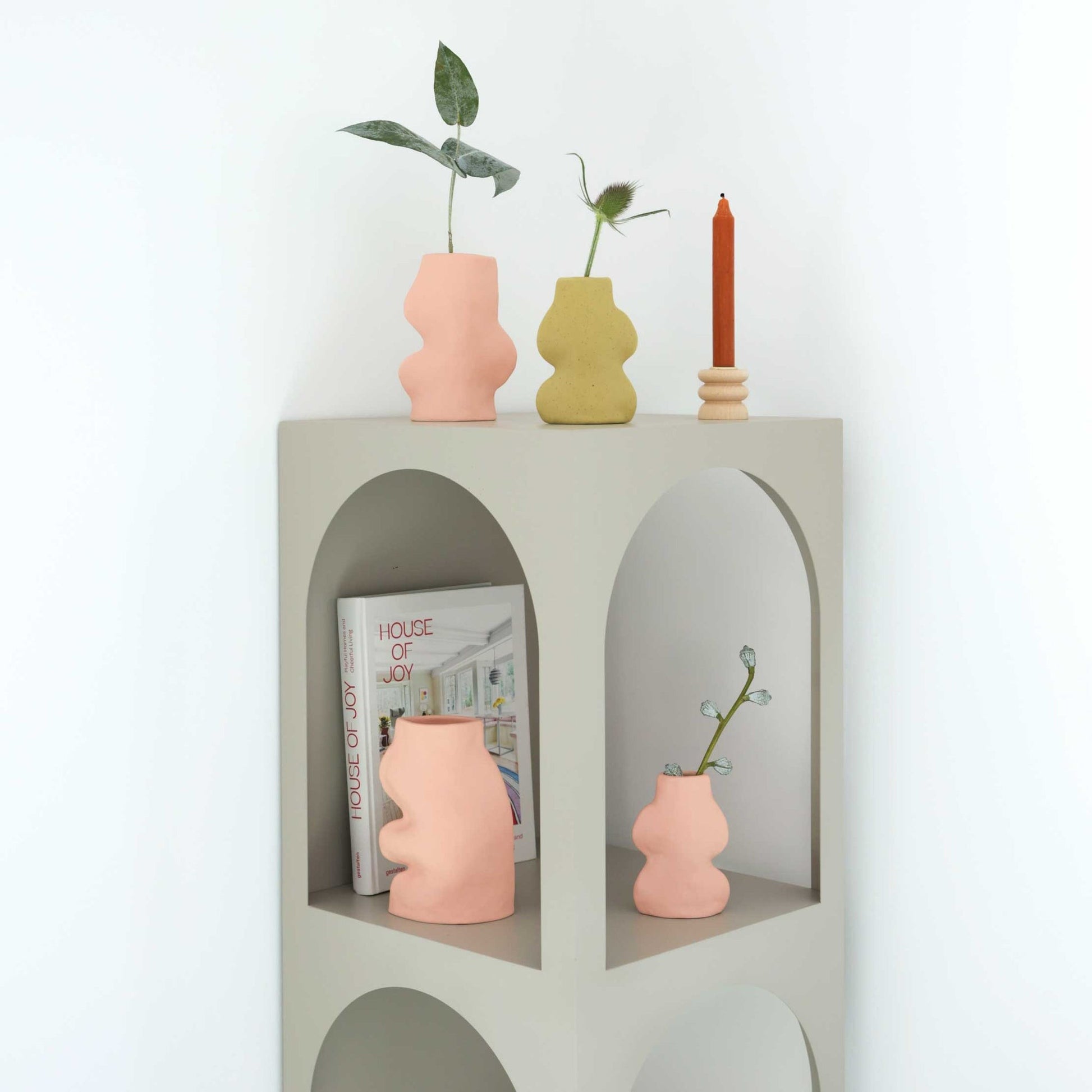 playful pink fluxo ceramic vase on a sunlit windowsill, casting a soft colorful shadow