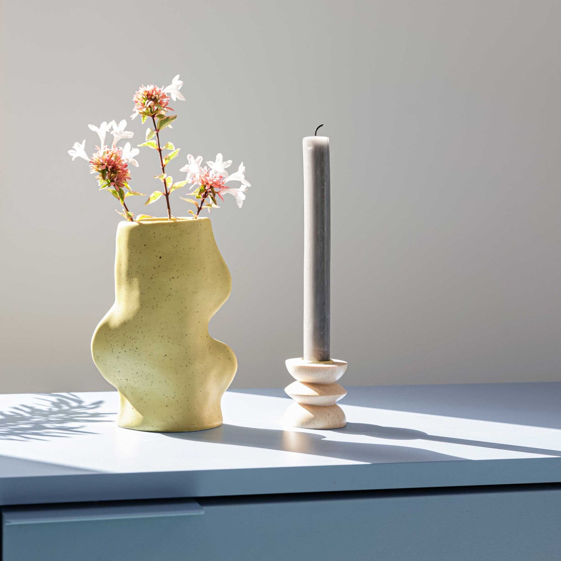 bold pistachio ceramic vase in dramatic studio light showcasing its unique handmade texture