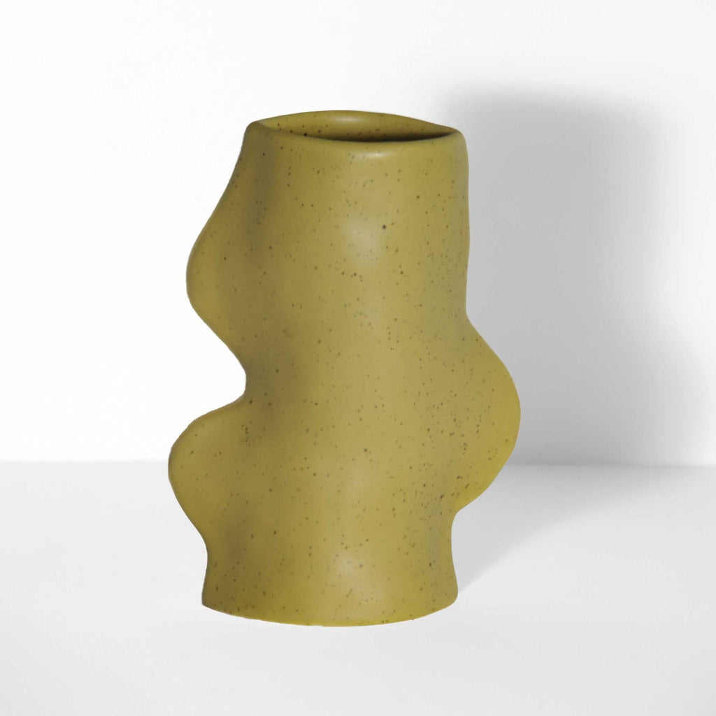 softly lit pistachio ceramic vase casting a gentle shadow on a cozy shelf