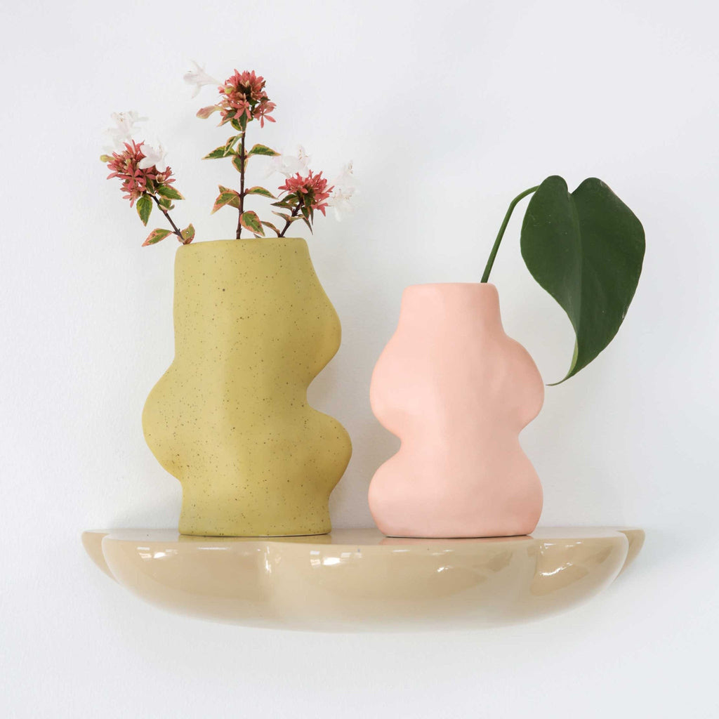 pistachio ceramic vase on a wooden table, shown from a practical side angle to display its stable base and versatile size for everyday use